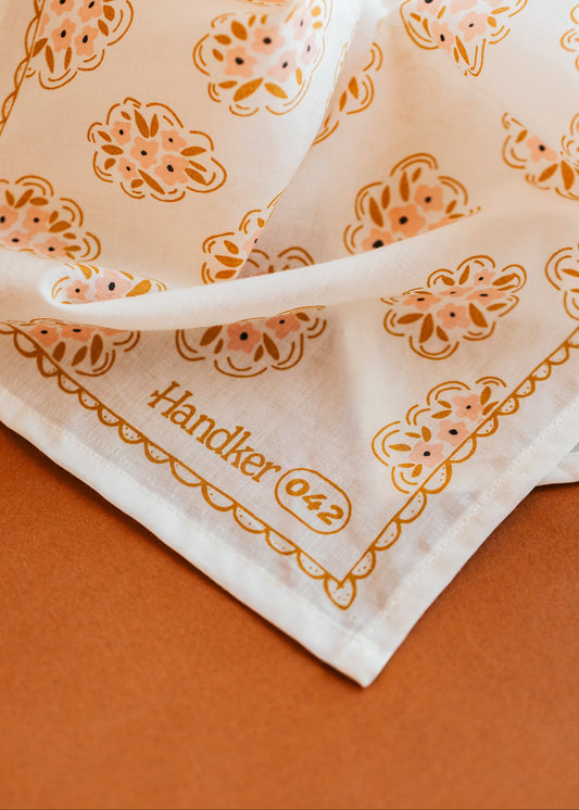 Handkerchief with floral pattern and 'Händker 042' text on a brown background