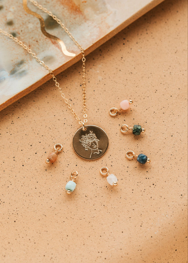 Gold Hello Adorn Mental Health necklace with circular pendants and meaning charms