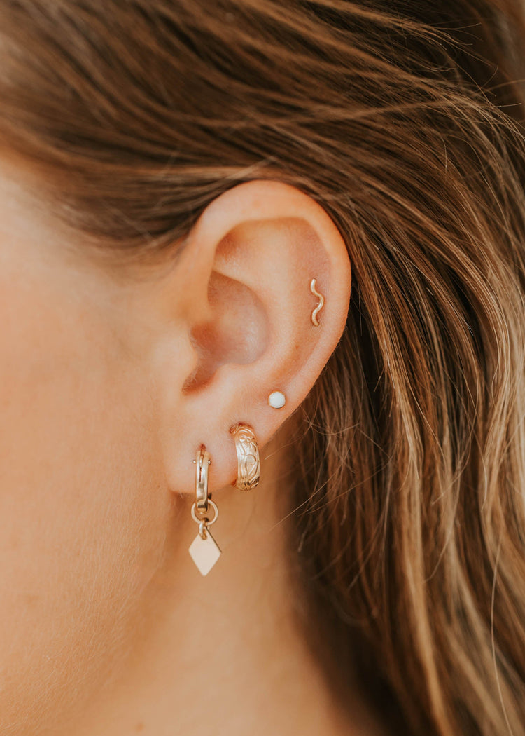 14k gold fill Tiny Wave Ear Climber earring in cartilage styled with opal stud, double gold hoops and kite charm drop by Hello Adorn