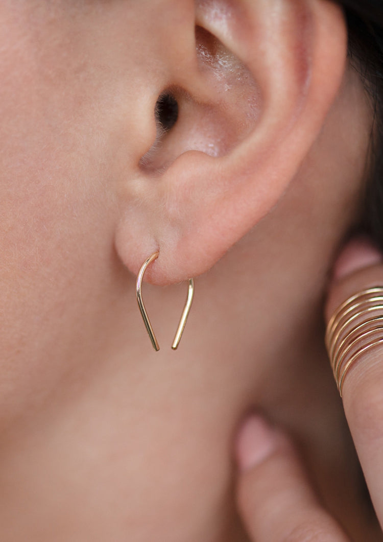 14k gold fill tiny horseshoe threader earrings by Hello Adorn worn on model styled with midi wrap ring