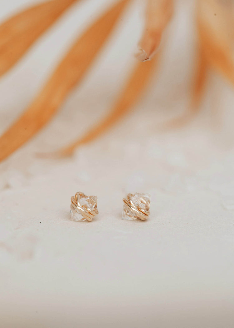 Close up view of herkimer diamond earrings by Hello Adorn shown in 14k gold fill.
