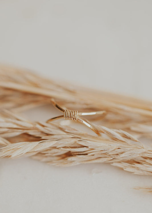 A wire wrapped ring made with two gold hammered rings to create the Cleo Ring by Hello Adorn.