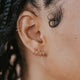 Close-up of tiny twist earrings