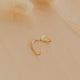 Gold ring on a beige background