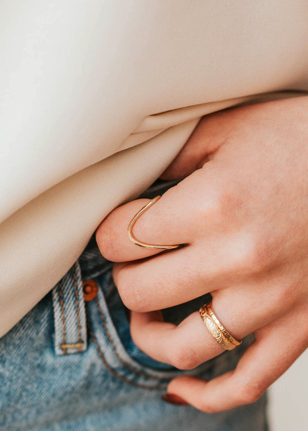 Close-up of a person buttoning a shirt with a blurred background