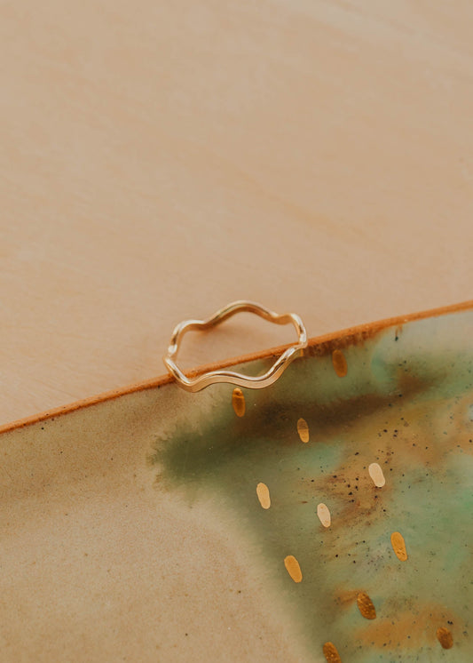 Gold ring on a ceramic plate with a textured surface