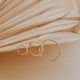 Thick gold hoops styled in an ear with small gold hoop earring and twist earrings by Hello Adorn in 14k gold fill.