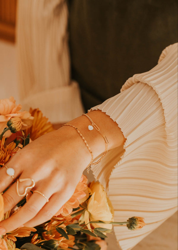 Hand holding a bouquet of flowers with a blurred background
