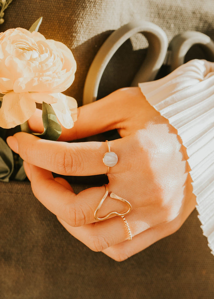 Close-up of hands holding a flower with a blurred background