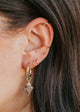 hoops and studs with charms on model with ear cuffs