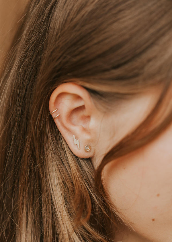 Gold ear cuff jewelry styled with lightning earrings and herkimer diamond studs in an ear by Hello Adorn. 