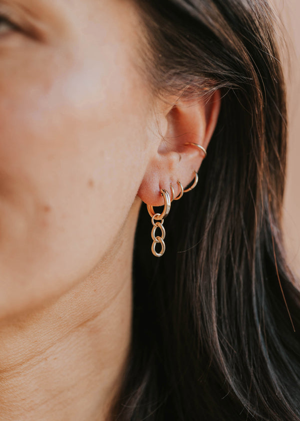 dangle earrings styled on model hoop charms