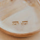 14k gold fill Tiny Wave Ear Climber earrings by Hello Adorn on a beige ceramic dish
