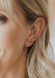Spiral hoop earrings shown styled with moonstone stud earrings by Hello Adorn.