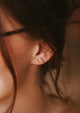 Gold bar stud earrings styled in an ear with tiniest bar studs by Hello Adorn.