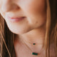A green stone necklace from Hello Adorn, the Tiny Gemma Necklace layered with the Gemma Necklace, two stone colorful pendants with a gold chain.