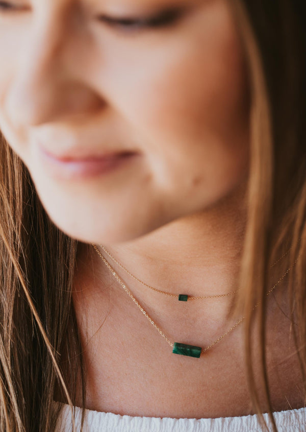 A green stone necklace from Hello Adorn, the Tiny Gemma Necklace layered with the Gemma Necklace, two stone colorful pendants with a gold chain.