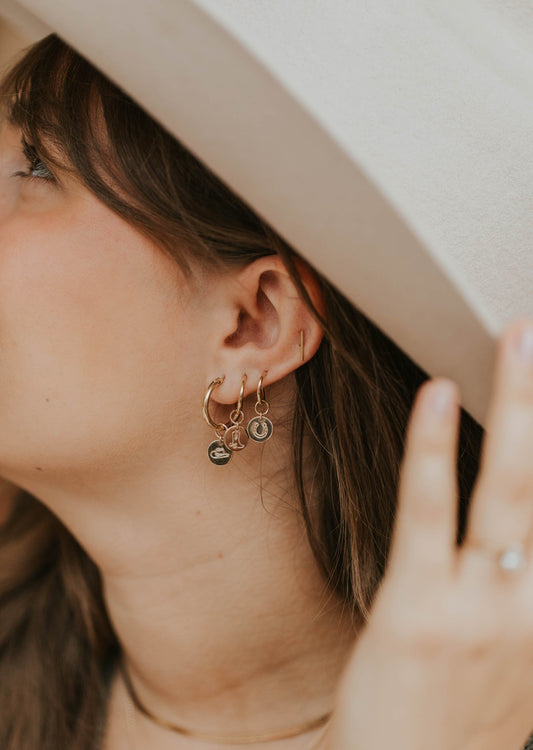 festival season cowgirl look with hoop earrings and charms