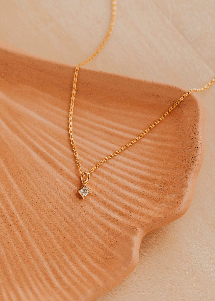 14K Gold Fill Grace Necklace by Hello Adorn - CZ star pendant on delicate chain on ceramic fan dish