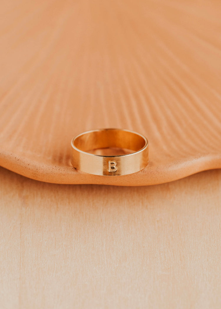 14K Gold Fill Bold Initial Band by Hello Adorn - single wide gold band engraved with letter B on ceramic dish