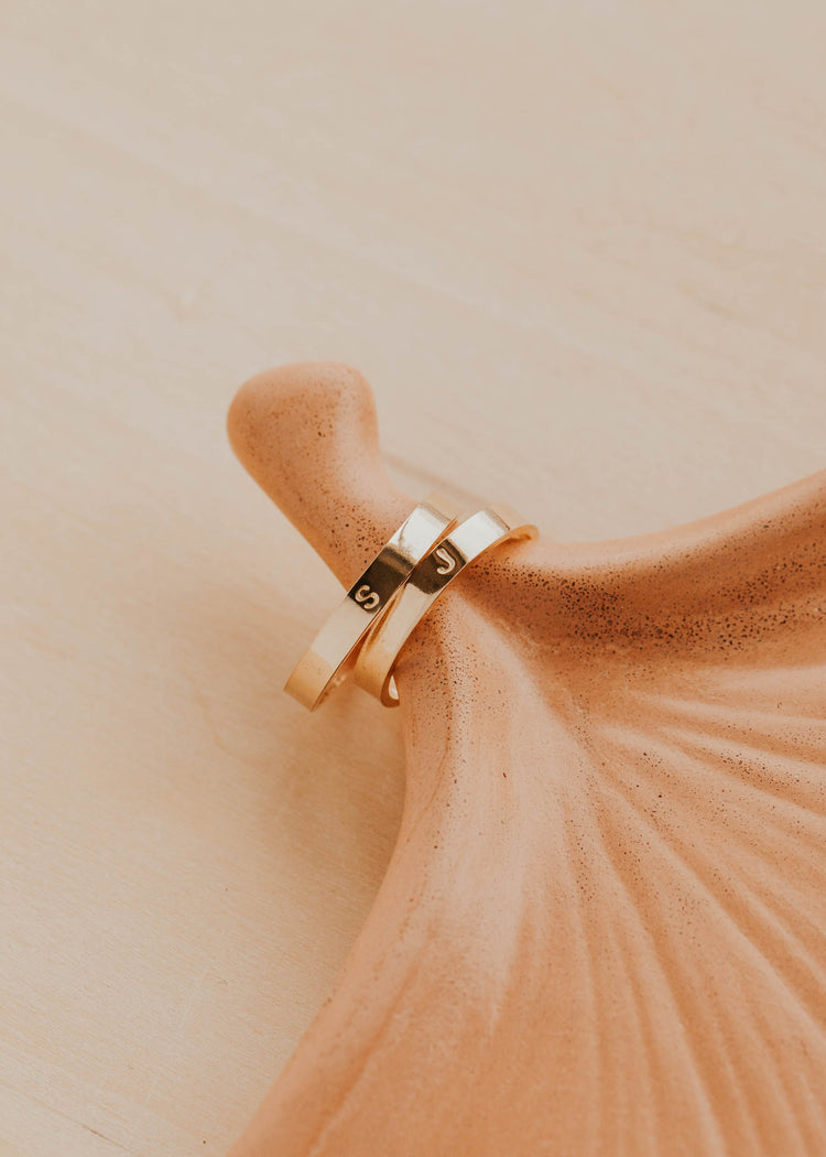 14K Gold Fill Classic Initial Band by Hello Adorn - two slim gold bands engraved with letters S and J on ceramic prop