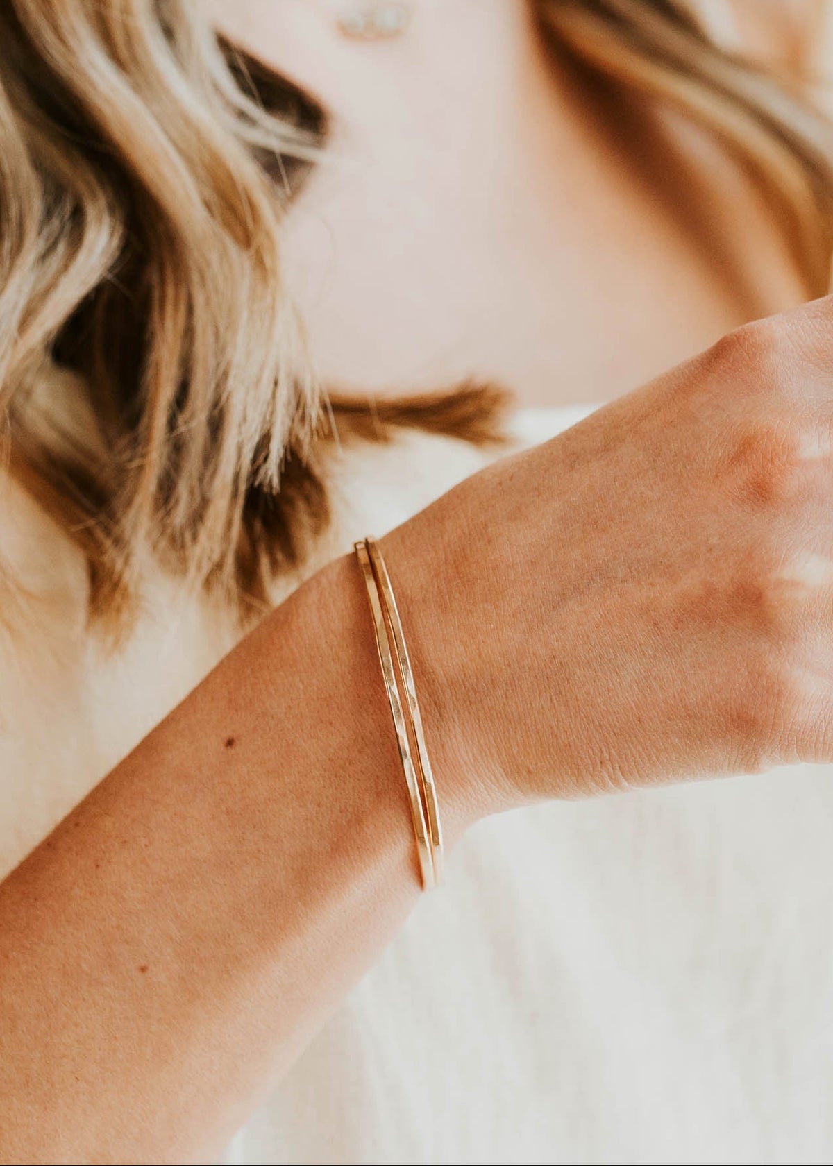 Person holding a black mug with a blurred background