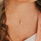 14K Gold Fill Rosalie Necklace by Hello Adorn - oval pink stone pendant worn on model's neckline with pink cardigan