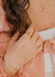14K Gold Fill Rosalie Ring by Hello Adorn - styled on model's hand with gold signet cuff bracelet and chain