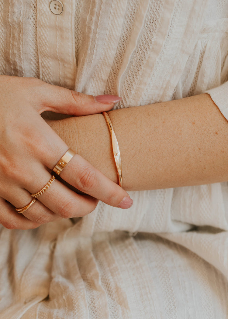 14K Gold Fill Signet Cuff by Hello Adorn - worn on model's wrist with initial band ring and delicate chain bracelets