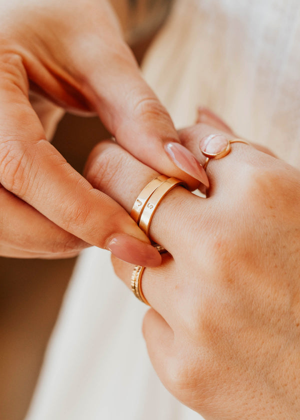 14K Gold Fill Classic Initial Band by Hello Adorn - two stacked gold bands engraved with initials on model's finger