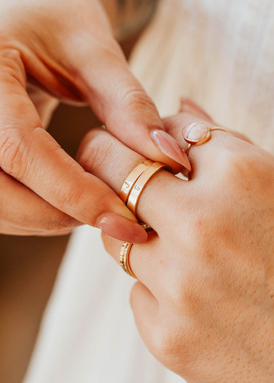 14K Gold Fill Classic Initial Band by Hello Adorn - two stacked gold bands engraved with initials on model's finger