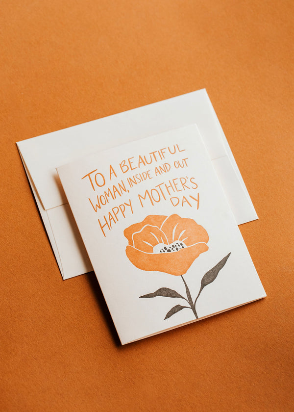 Greeting card with floral design and text on an orange background