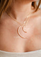 Two gold moon necklaces in crescent moon necklace styles, one with a small moon pendant and one with a large moon pendant attached to chain necklaces created by Hello Adorn.
