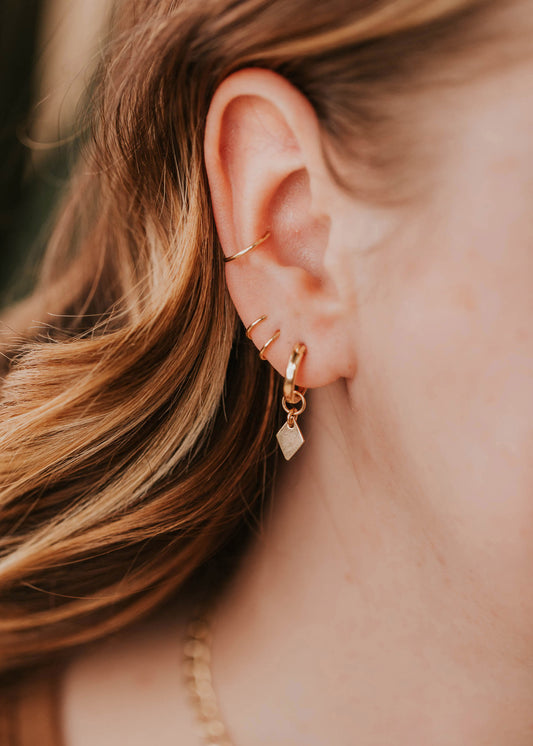 diamond shape charms on model styled in ear