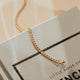 Gold bracelet on a Balenciaga book