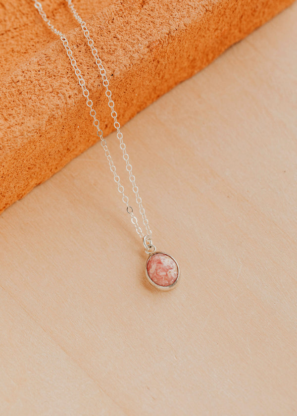 Sterling Silver Rosalie Necklace by Hello Adorn - oval pink stone pendant on silver chain against terracotta prop