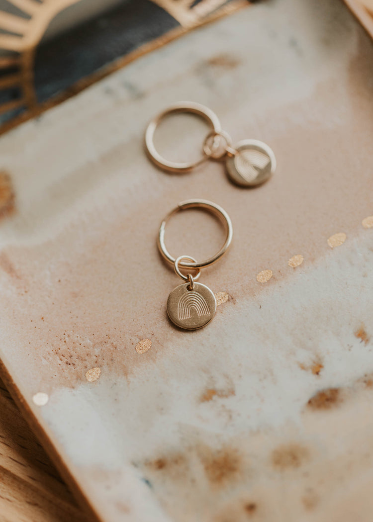 flat lay image of rainbow hoop charms