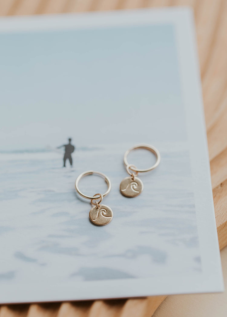 surfer with hoop earrings and wave charms earrings for surfer girls
