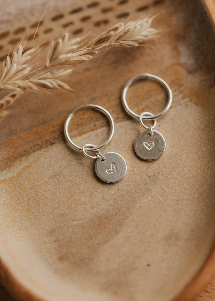 stamped charms with a heart in sterling silver metal
