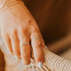 A 3 ring stack featuring two confetti bands created with a hammered ring and beaded ring styled with a thicker wire wrap ring paired with a bracelet stack by Hello Adorn.