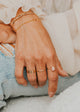 14K Gold Fill Rosalie Ring by Hello Adorn - worn on model's finger with gold initial band and chain bracelets