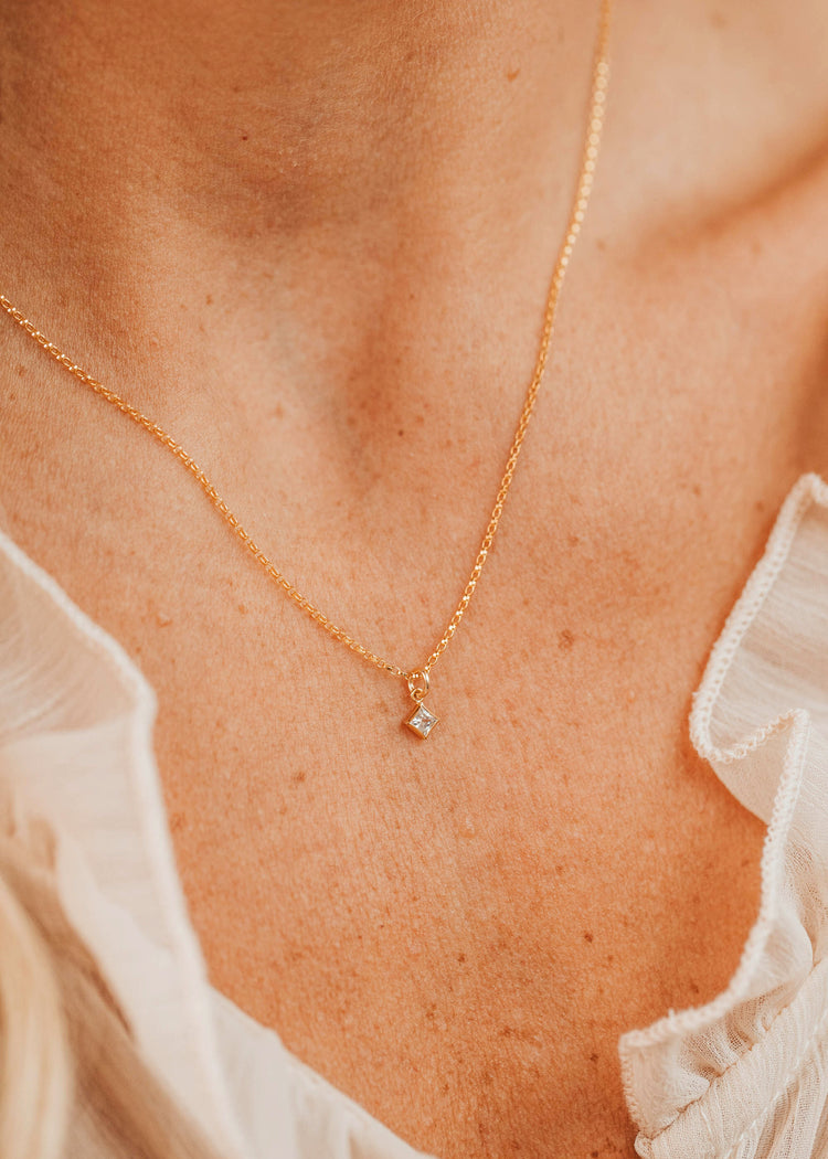14K Gold Fill Grace Necklace by Hello Adorn - tiny CZ star pendant on delicate chain worn on model's chest