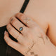 Hand with tattoos and rings on a blurred background