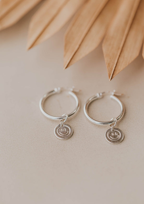 silver earrings with smiley face charms