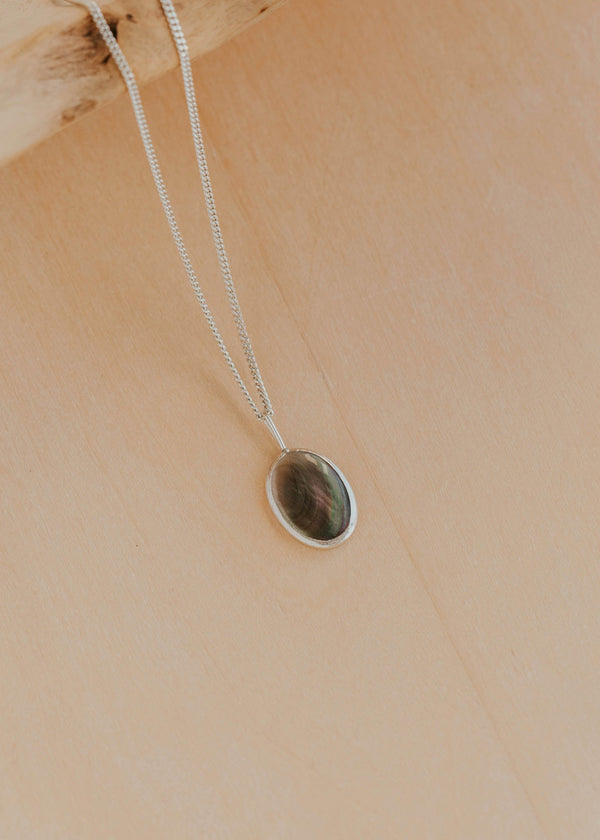 Necklace with a pendant on a beige background