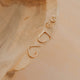 Gold earrings on a wooden surface