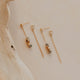 Pair of gold earrings on a neutral background