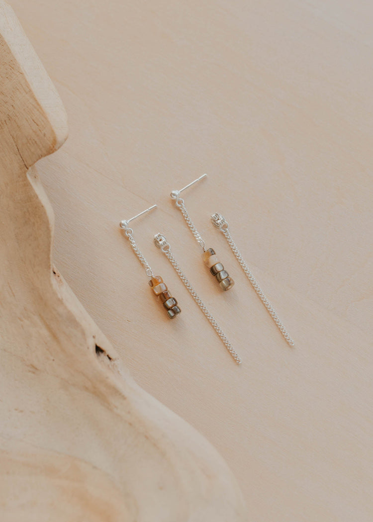 Set of gold earrings on a wooden surface