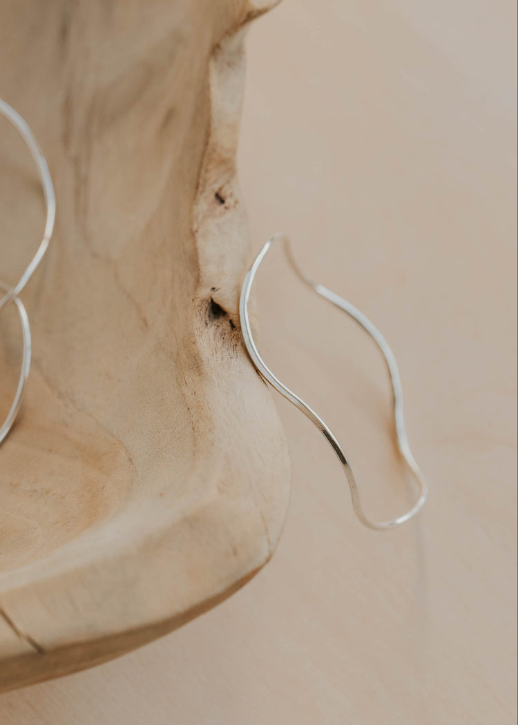Silver bangle bracelet on a wooden surface