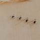 Set of three earrings on a beige background